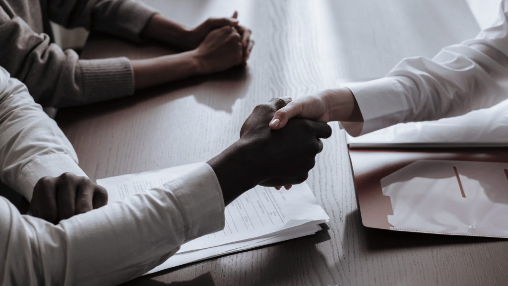 How to Negotiate a Better Salary After Receiving a Job Offer. Photo of hiring manager shaking hands with the job seeker who negotiated a higher salary.